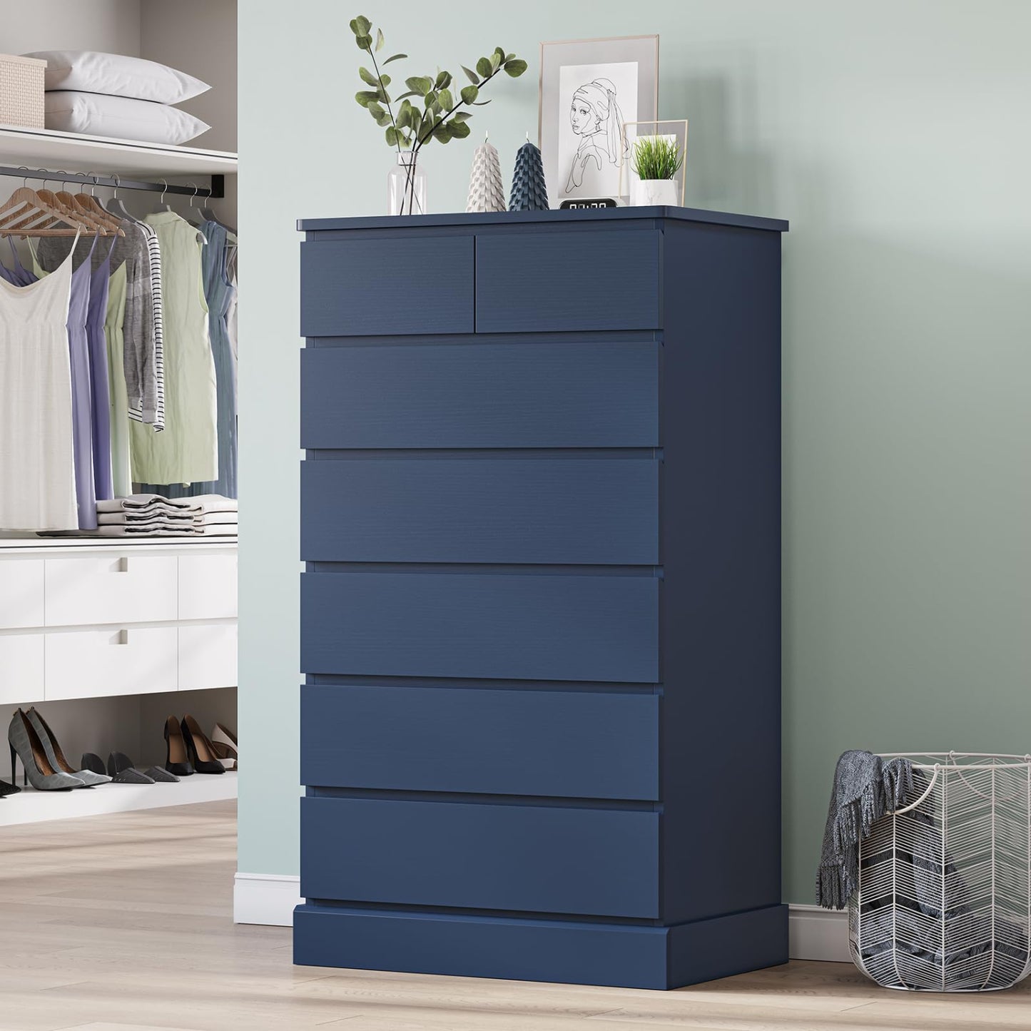 Blue dresser in a room with a wardrobe and laundry basket.