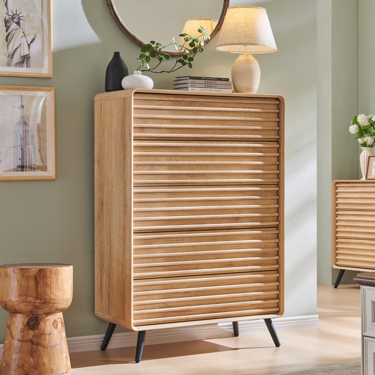 Wooden cabinet with slatted design in a room with green walls and decorative items.
