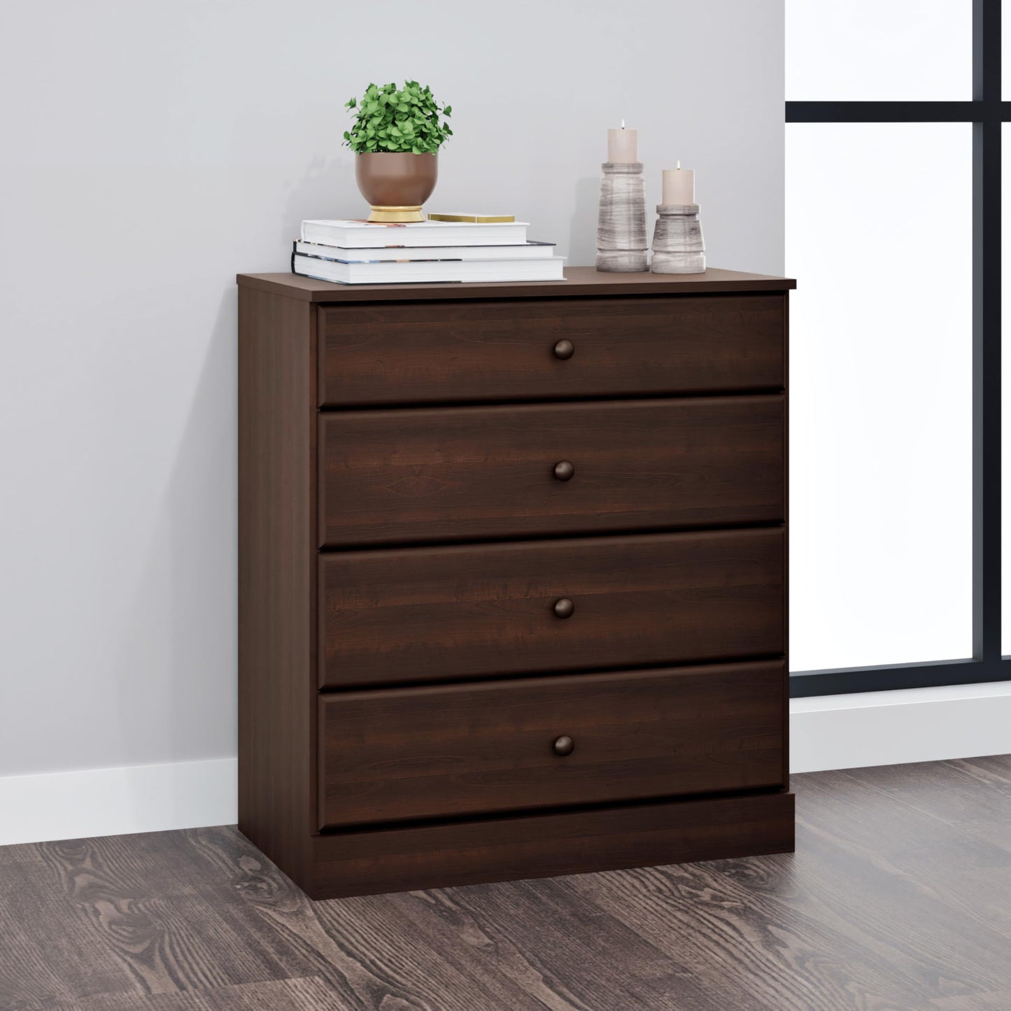 Wooden dresser with three drawers on a wooden floor against a gray wall.