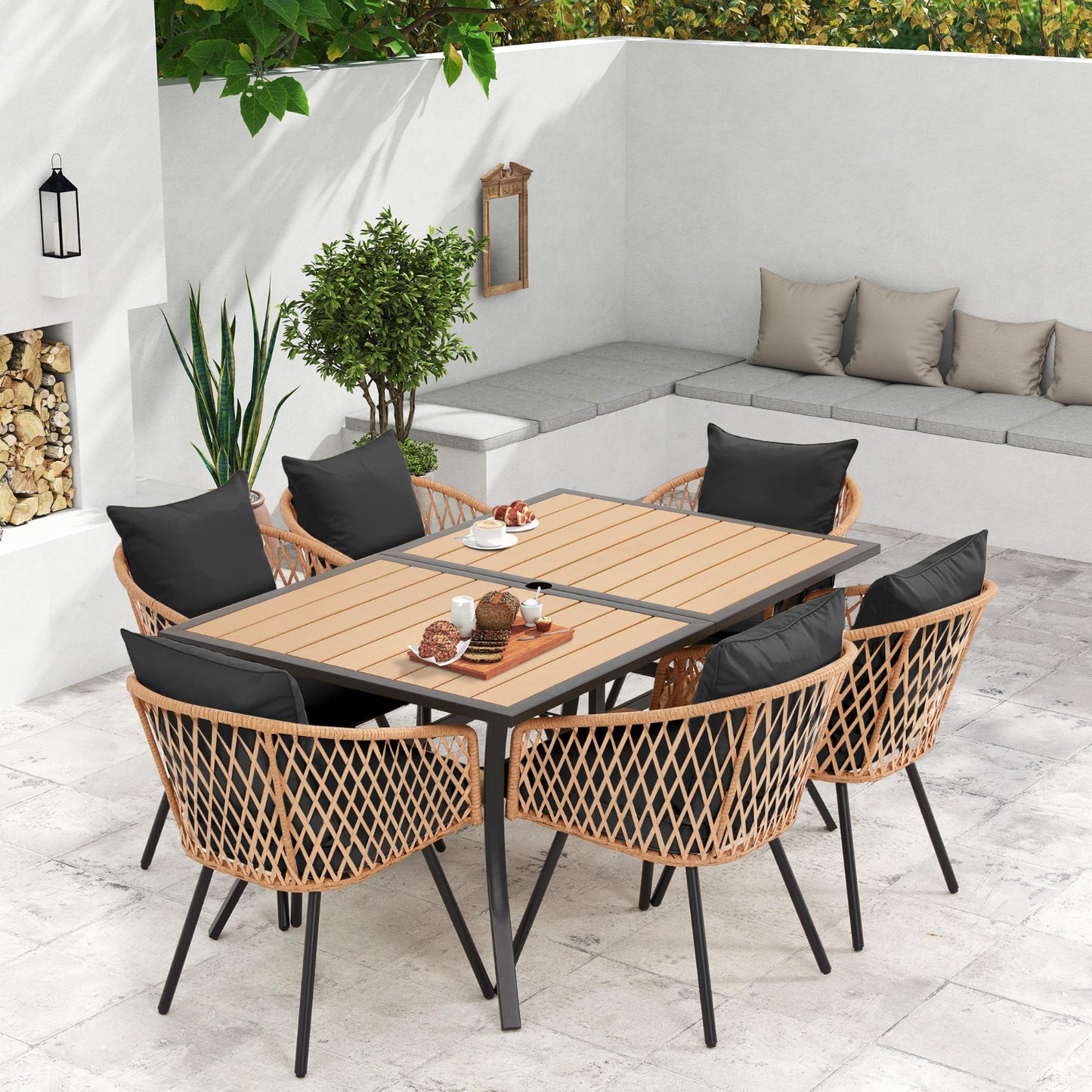 Outdoor patio set with table, chairs, and cushions in a modern garden setting.