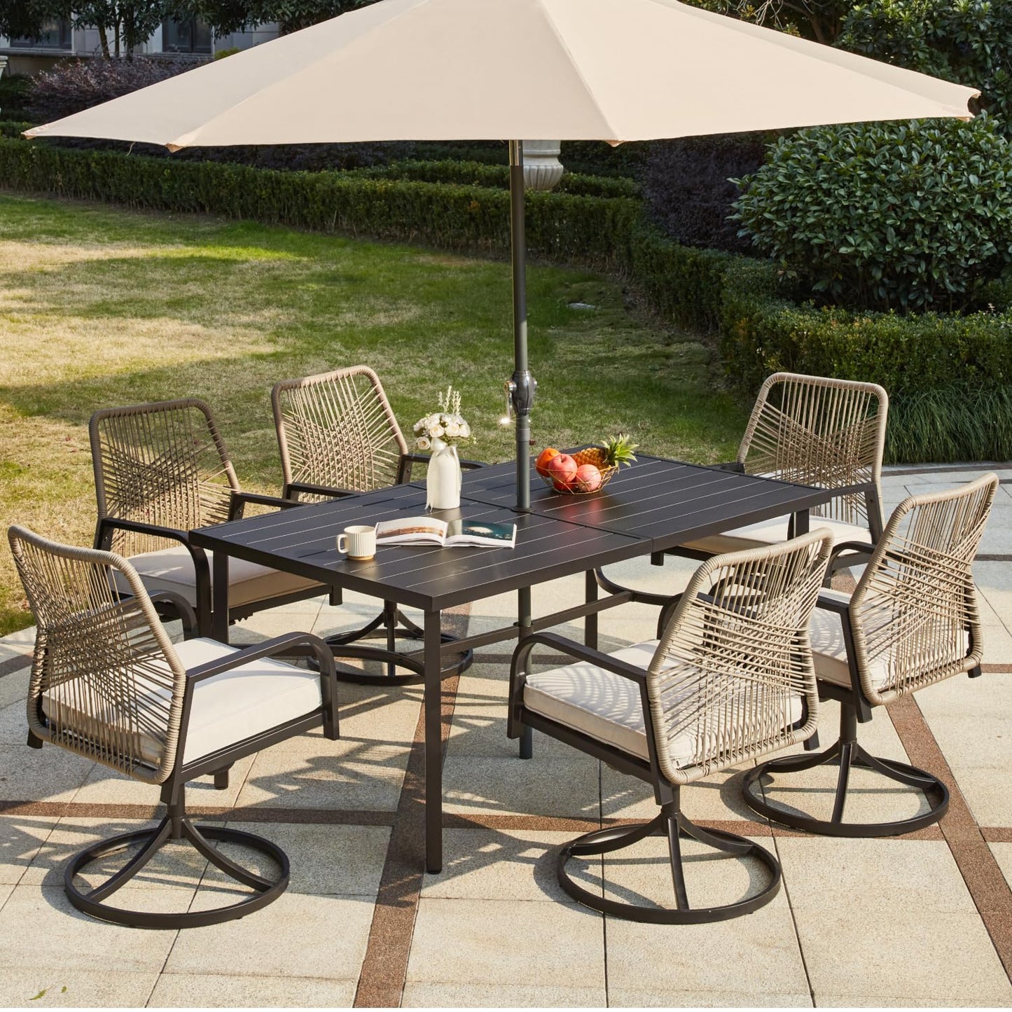 Outdoor dining set with table and chairs under a large umbrella on a patio.