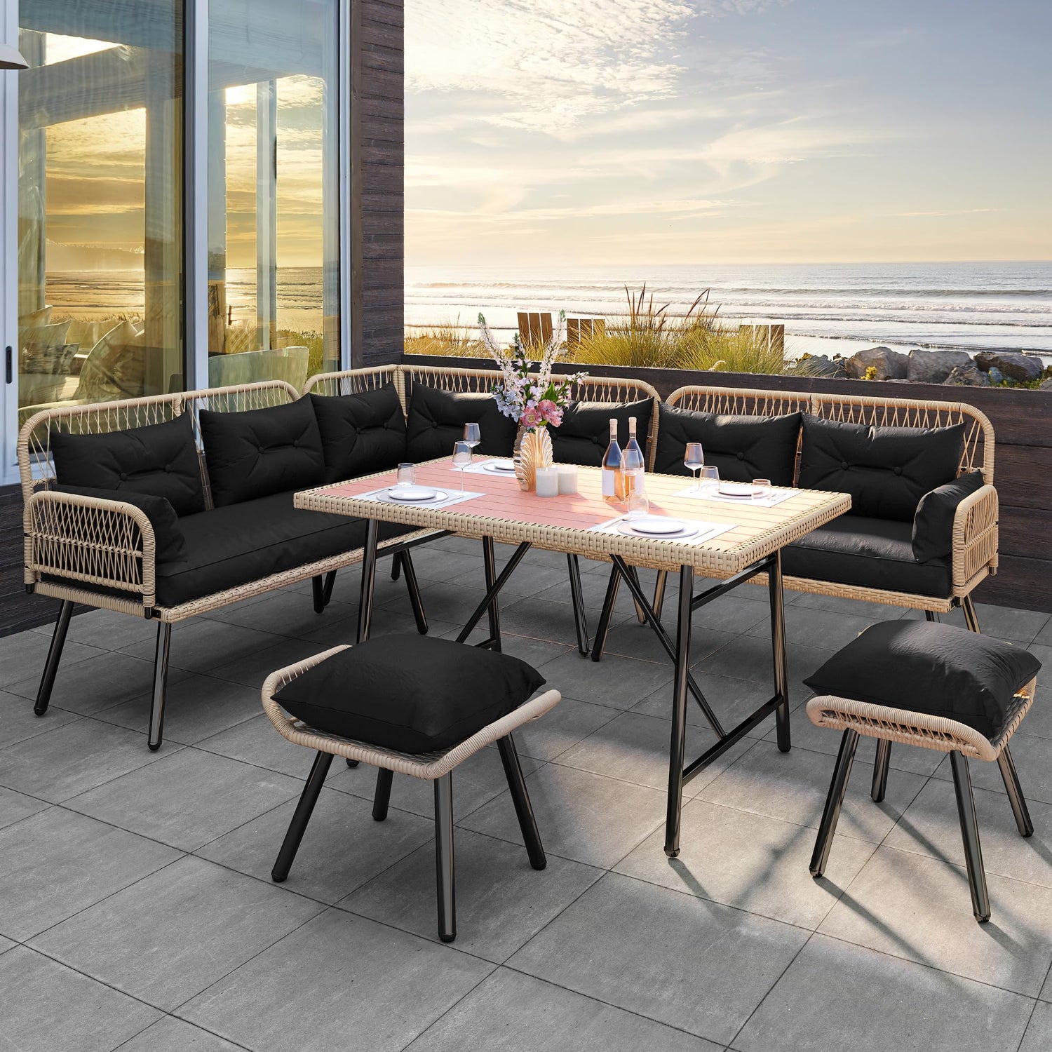 Outdoor patio set with sectional sofa, table, and stools on a tiled patio with ocean view.