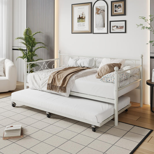 White metal bed with pull-out trundle in a room with decor elements.