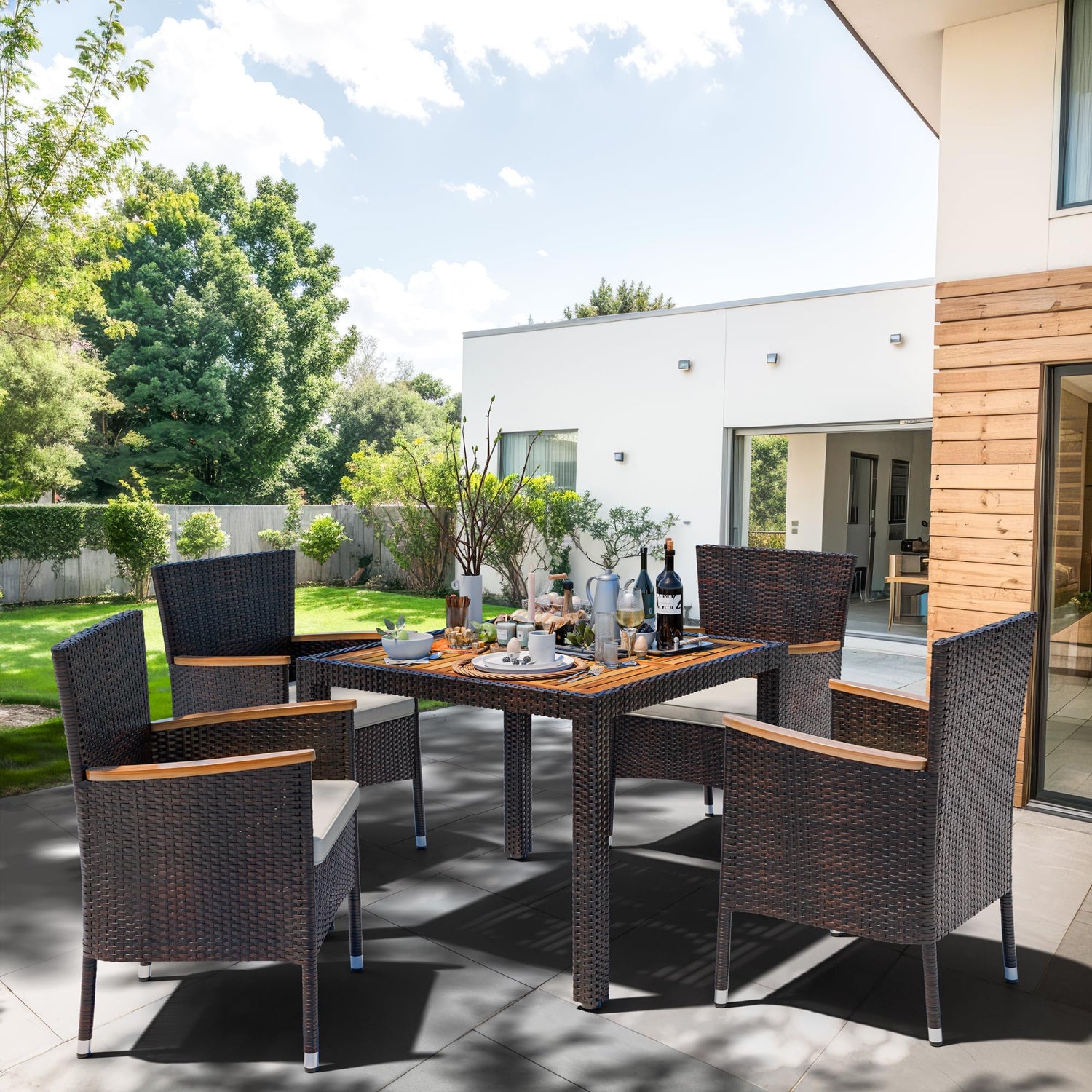 Outdoor patio set with table and chairs on a patio area.