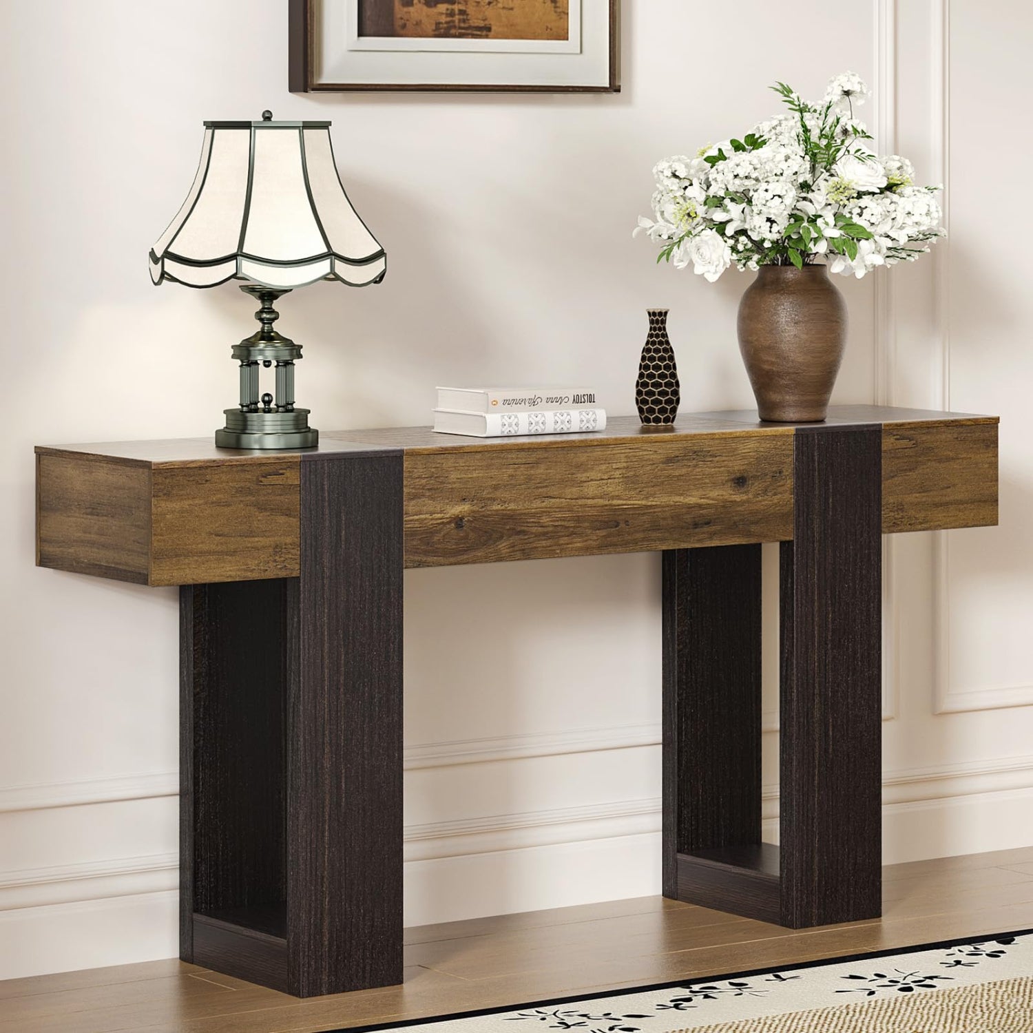 Wooden console table with decorative items against a wall.