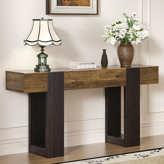 Wooden console table with decorative items against a wall.