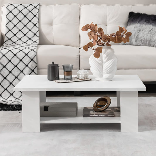Modern living room with a white sofa, coffee table, and decorative items.
